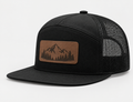 Black Richardson 168 Hi-Pro seven-panel trucker hat with mesh back and a custom brown leatherette patch