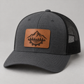 Charcoal Richardson 112 style trucker hat with a custom walnut leatherette patch